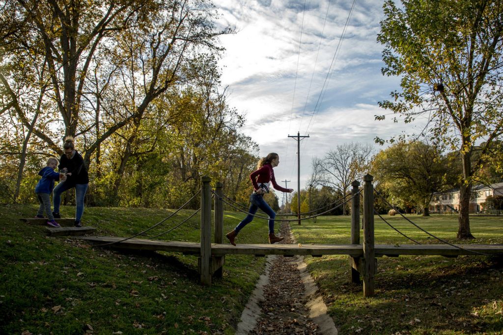 First Place, Feature Picture Story - Jessica Phelps / Newark Advocate, “Living on Love”Sophia Hrebluk leads her mom (Leah) and sister (Kyndall) across a bridge from the bike path back to their home after an afternoon walk on October 24, 2019. Sophia has cerebral palsy and has had to fight for a lot in this world. Her experiences have given her empathy and intuition and a unique way of seeing the world. She helps her mom care for her younger sister, Kyndall who was born with Down syndrome. 